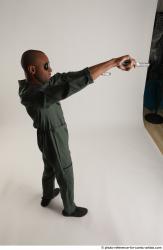 ERIC STANDING POSE WITH GUNS